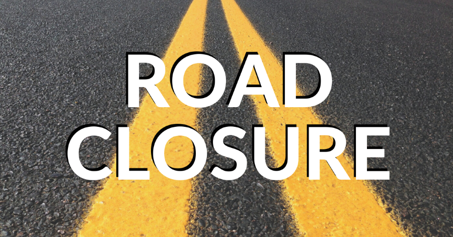 the words road closure on a paved road background