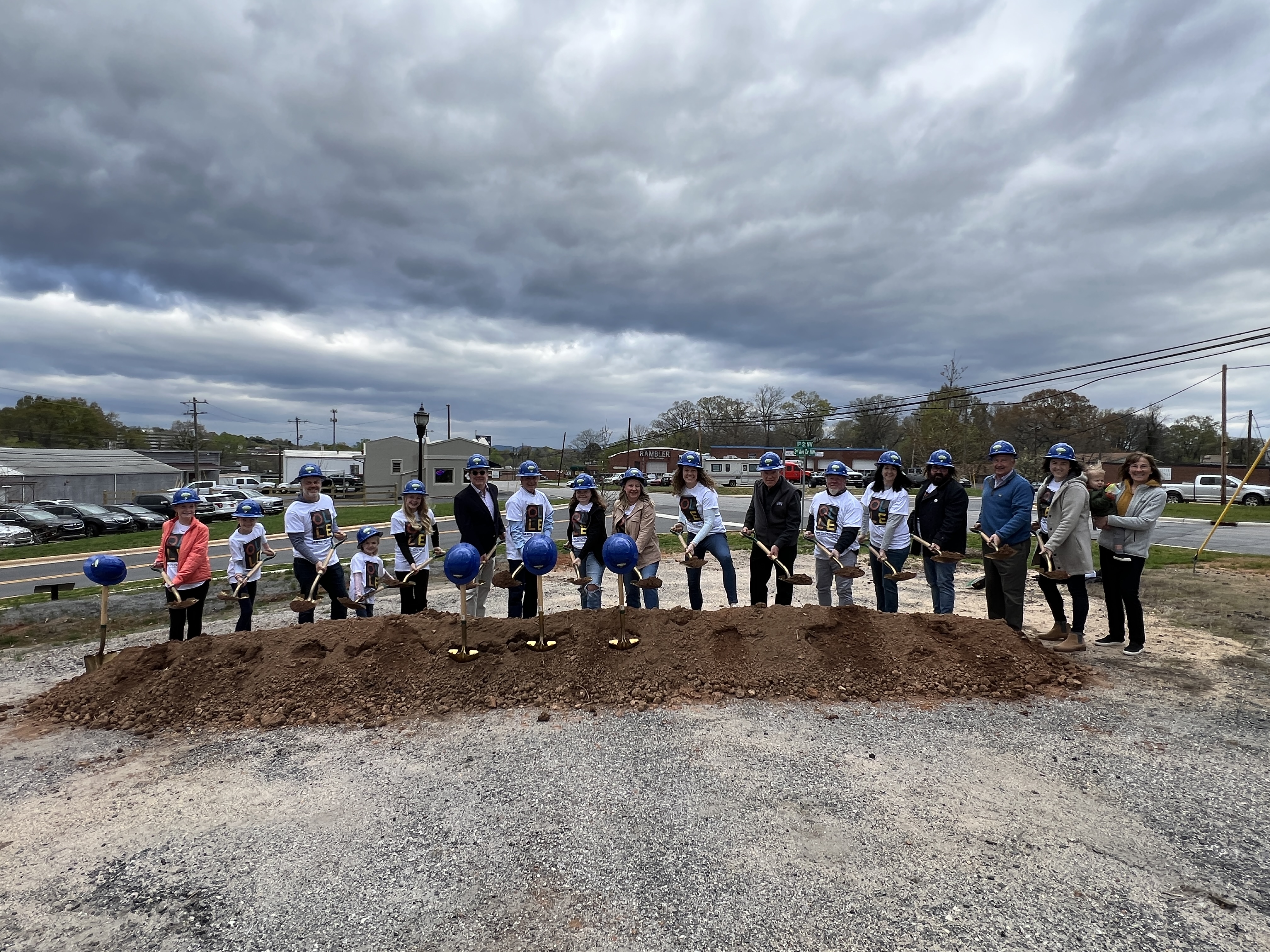 OLLE Arts District members take turns shoveling dirt at the groundbreaking