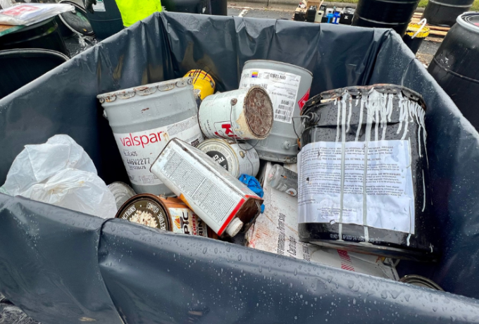 paint cans in a bin