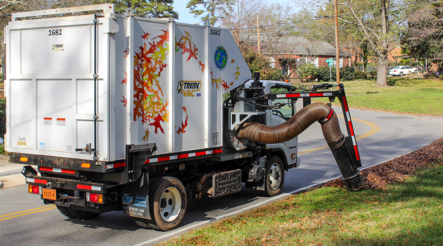 leaf collection truck vacuuming leaves