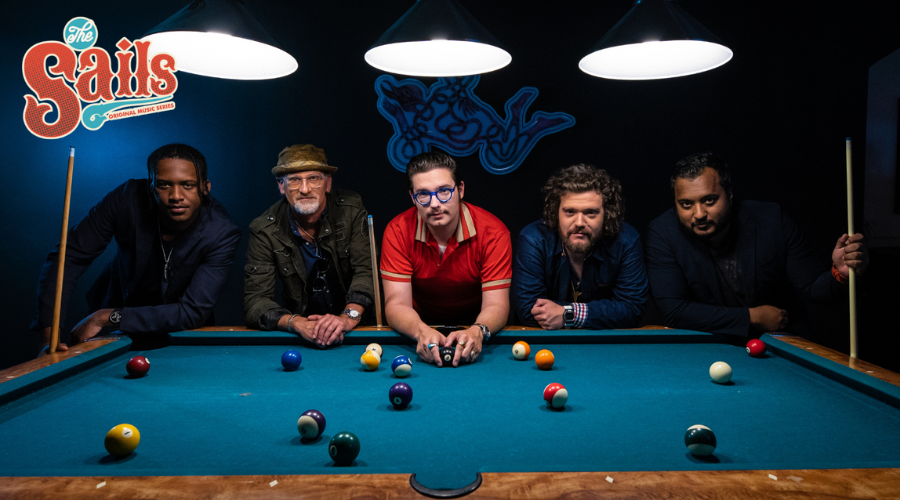 Eddie 9V and band members around a pool table