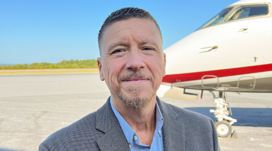 Airport Manager Terry Clark stands in front of a plane at Hickory Regional Airport