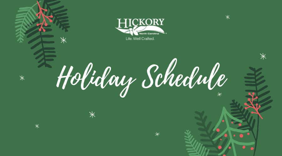 green background with evergreen branches and the words Holiday Schedule