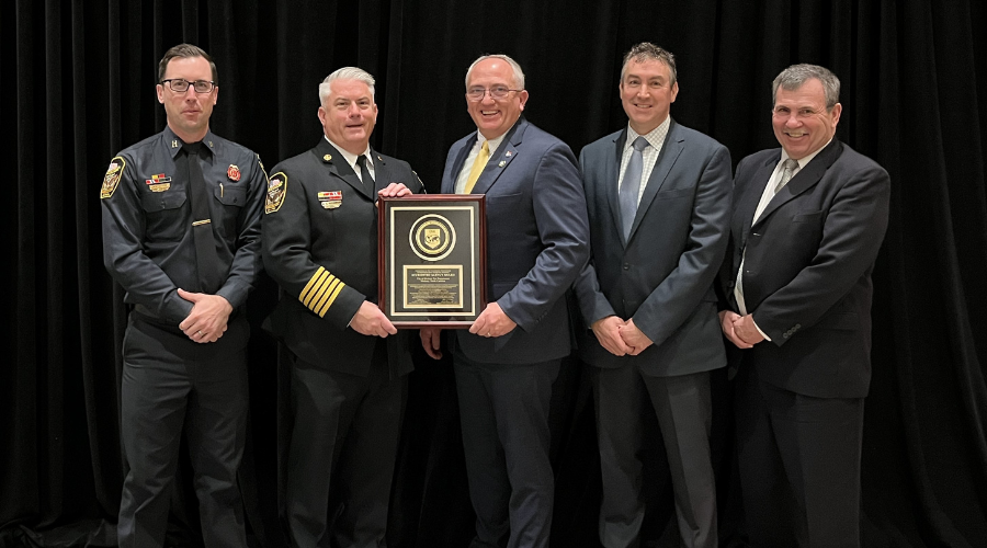 Photo of Hickory Fire Department staff, City management and CFAI representatives with the Accreditation Award plaque