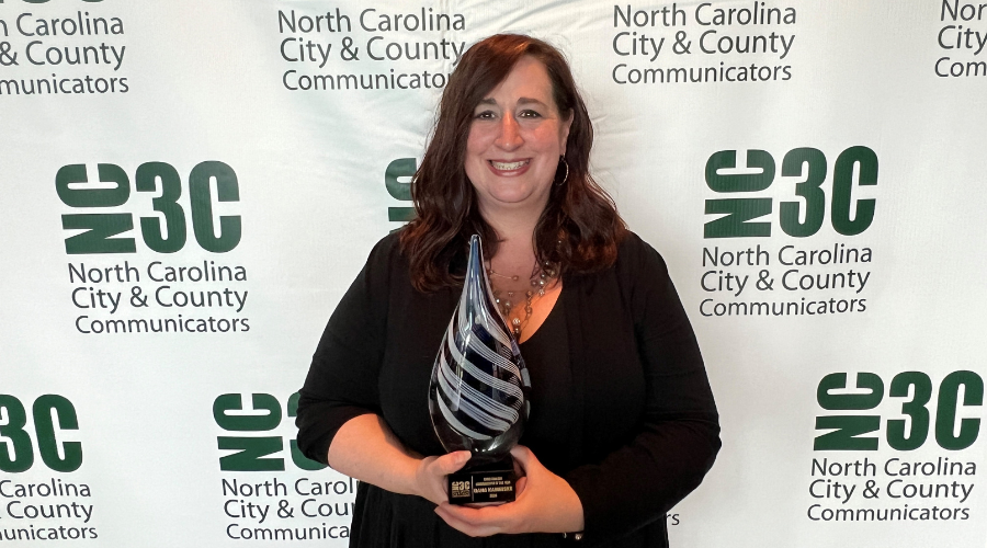 Dana Kaminske holds the Communicator of the Year Award