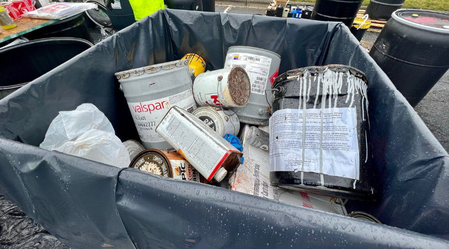 paint cans in a bin