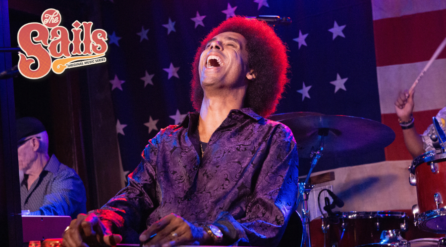 Selwyn Birchwood singing and playing the slide guitar