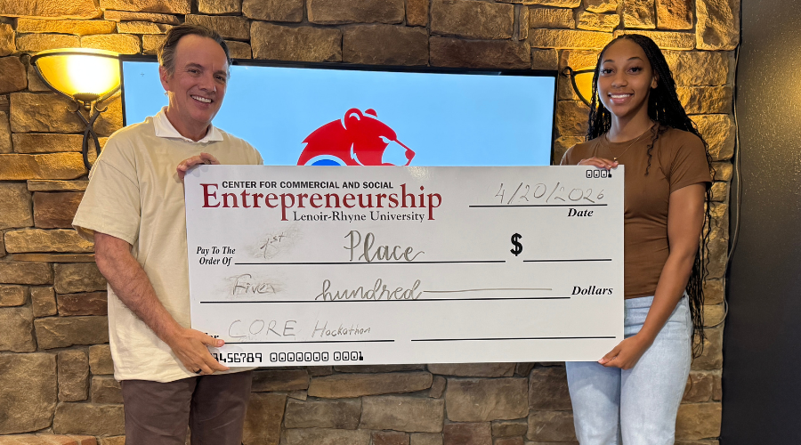 CORE Hackathon winner Lauren Arnold is presented with her prize check