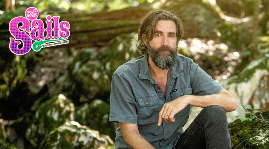Tyler Ramsey crouching in a wooded setting